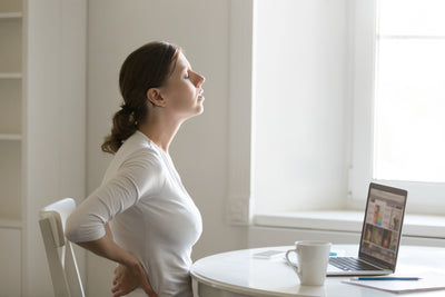 profile-portrait-woman-desk-stretching-backache-positio